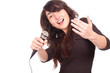 young woman holding a microphone and singing loud