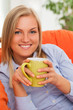 Photo: Young blond woman with mug Young blond woman with mug