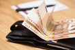 Photo: Heap of euro banknotes on a wooden table Heap of euro banknotes on a wooden table