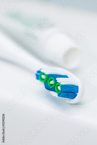Photo: Closeup image of toothbrush and tube Closeup image of toothbrush and tube