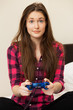 Young woman in casual playing videogame