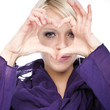 Beautiful woman making a finger heart sign