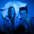 Photo: Caucasian couple watching scary movie Caucasian couple watching scary movie