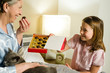 Granddaughter offering pralines to grandmother