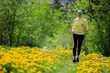 Runner - woman running outdoors, active adult concept