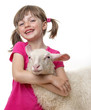 Foto: a happy little girl with a sheep a happy little girl with a sheep