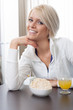 Photo: Beautiful woman enjoying a healthy breakfast Beautiful woman enjoying a healthy breakfast