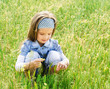 Foto: Cute little girl on the meadow Cute little girl on the meadow