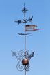 Vintage weather vane above blue sky in Tallinn