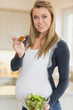 Pregnant woman eating salad
