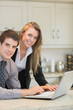 Happy couple using laptop