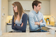 Divided couple with arms crossed