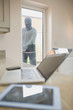 Photo: Burglar opening kitchen door and looking at laptop Burglar opening kitchen door and looking at laptop