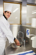 Photo: Cheerful chef washing hands Cheerful chef washing hands