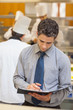 Waiter writing in folder
