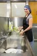 Photo: Smiling woman using a sponge Smiling woman using a sponge