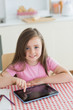 Happy little girl using tablet computer