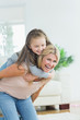 Mother giving daughter a piggy back