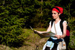 Woman with a map in forest