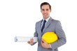 Photo: Smiling architect holding plans and hard hat Smiling architect holding plans and hard hat