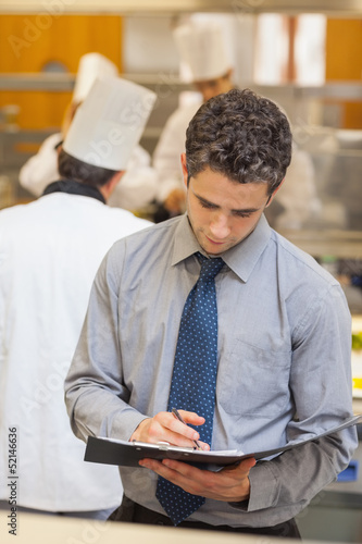 Photo: Waiter writing in folder Waiter writing in folder