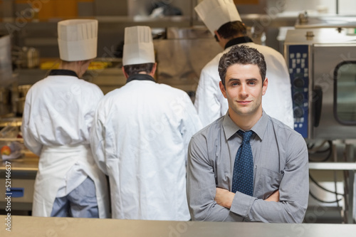 Photo: Waiter standing in the kitchen Waiter standing in the kitchen