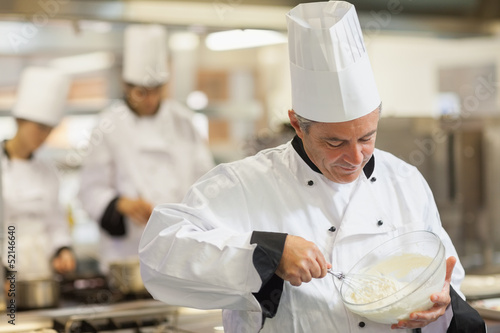 Photo: Happy chef whisking cream Happy chef whisking cream