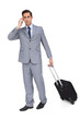 Foto: Serious businessman on the phone while holding his suitcase Serious businessman on the phone while holding his suitcase