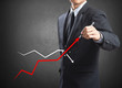 Businessman drawing a growth graph