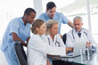 Serious medical team using a laptop