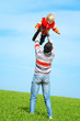 Happy father and son playing on sky background