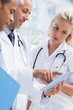 Doctor showing something in his tablet