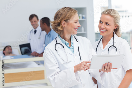 Photo: Smiling doctors talking to each other Smiling doctors talking to each other
