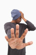 Man in beanie hat holding hand out to stop
