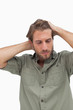 Photo: Stressed man looking down with hands on head Stressed man looking down with hands on head