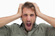 Furious man with hands on head