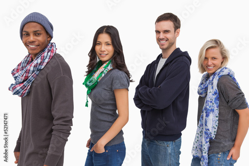 Photo: Stylish young people in a row smiling Stylish young people in a row smiling
