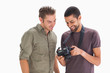 Photo: Stylish men looking at digital camera Stylish men looking at digital camera