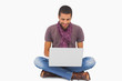Photo: Stylish man sitting on floor using laptop Stylish man sitting on floor using laptop