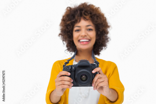 Photo: Happy girl holding a camera Happy girl holding a camera