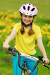 Photo: Bike riding - young girl on bike, active child concept Bike riding - young girl on bike, active child concept