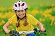 Photo: Bike riding - young girl on bike, active child concept Bike riding - young girl on bike, active child concept