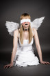 fallen angel sitting on the floor