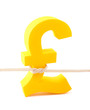 Foto: Golden pound symbol tied with rope Golden pound symbol tied with rope