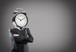 Businessman with alarm clock on head