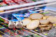 Dices cubes with the words SELL BUY, one-euro coins and a financ