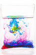 A drops of colored liquid was just poured into a clear glass
