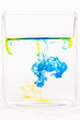 A drops of colored liquid was just poured into a clear glass