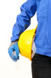 Yellow hardhat under arm against white background
