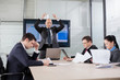 Photo: Angry and disappointed boss throwing documents during briefing Angry and disappointed boss throwing documents during briefing